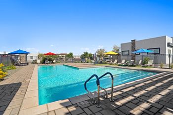 Our apartments have a swimming pool with chairs and umbrellas